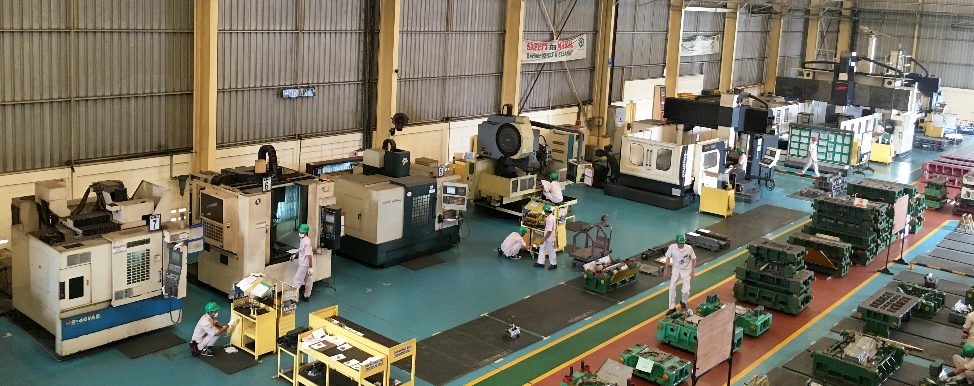 Color photo of CNC machines across a real factory floor