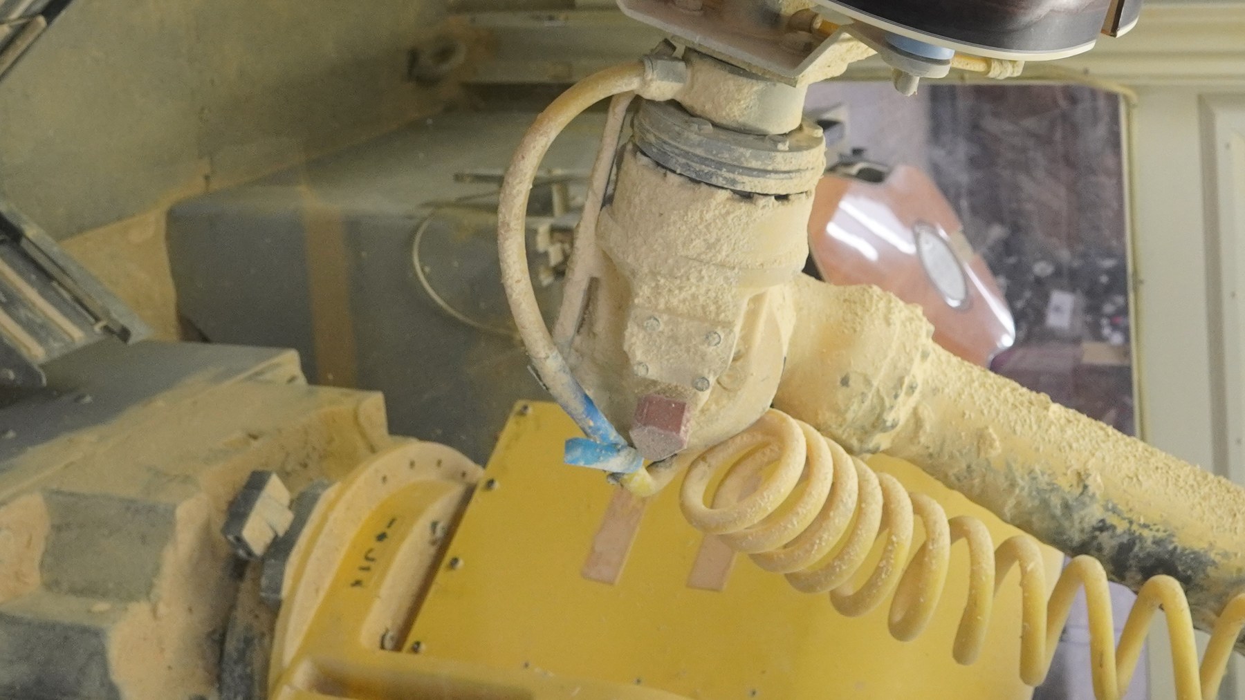 Industrial robotic arm working inside an automated production cell